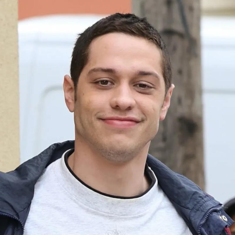 Pete Davidson is an American actor and comedian. He was born on 16 November 1993. Peter Michael Davidson is his complete name. He was a member of the SNL cast from 2014 to 2022. His dad, Scott Matthew Davidson, was a firefighter for the New York City Fire Department who lost his life in the World Trade Center on September 11, 2001.