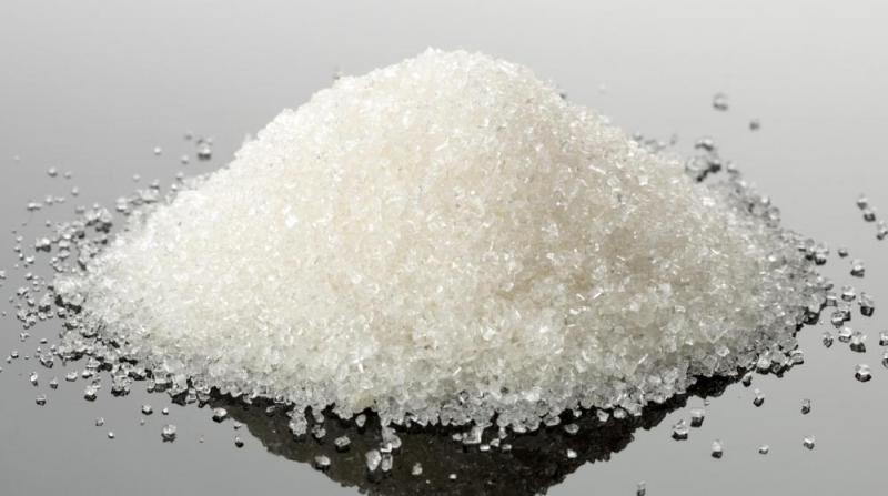 pile-of-white-granules-on-reflective-surface